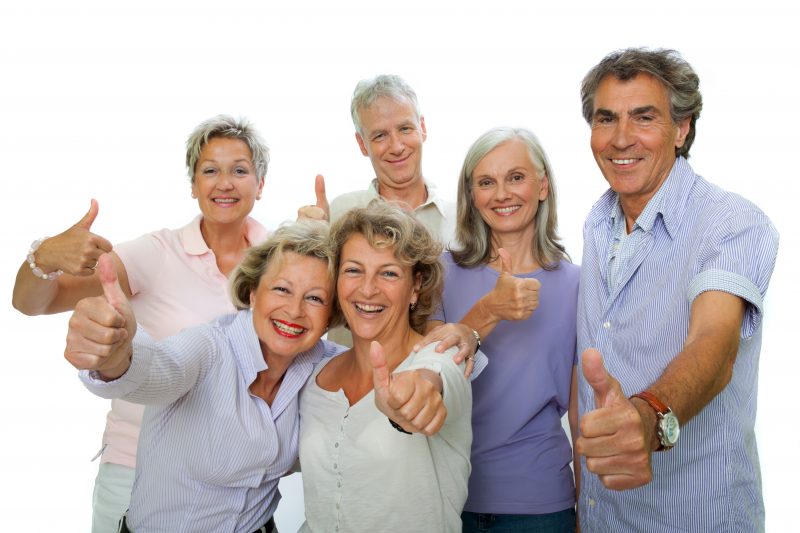 A group of middle-aged people giving the thumbs up